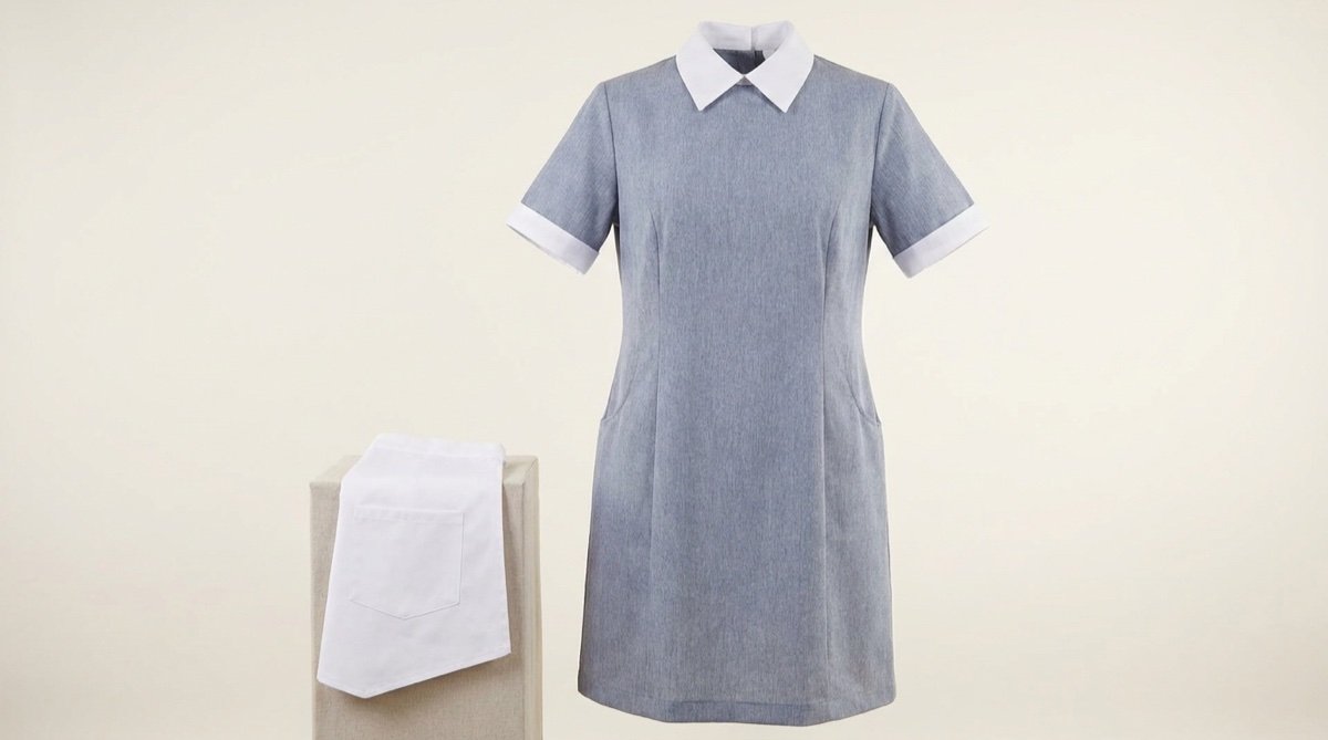 Housemaid uniform dress in grey-blue poly-cotton with white collar and cuffs, shown with a folded white apron
