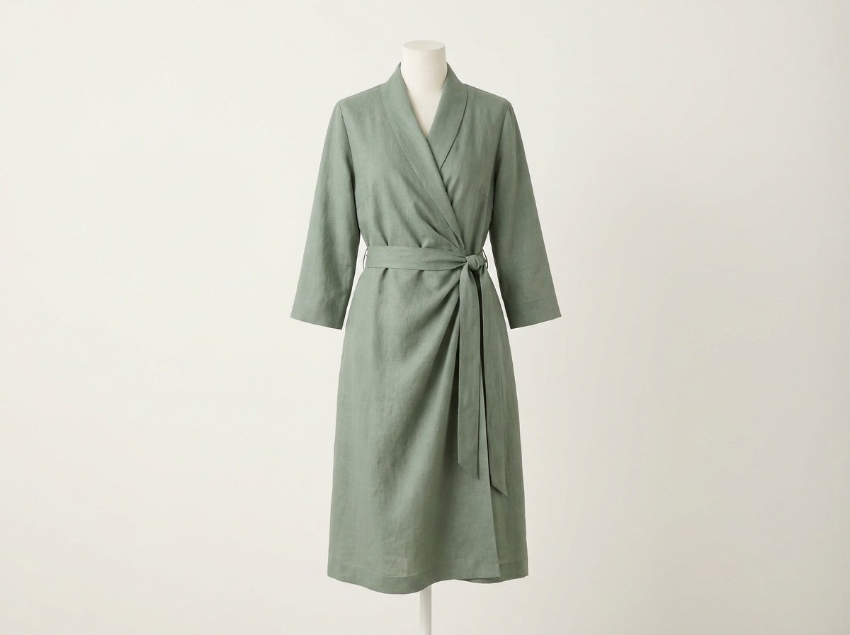 Spa reception uniform: tailored sage green wrap dress with tie waist and three-quarter sleeves